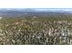 An aerial view of a treed lot with mountains in the background at 14800 Gold Hill Rd, Boulder, CO 80302