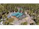 Stunning aerial view of the home surrounded by lush forest, solar panels, and a spacious outdoor deck at 14800 Gold Hill Rd, Boulder, CO 80302