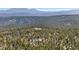 Scenic aerial view of the mountain property surrounded by lush trees and mountain views in the background at 14800 Gold Hill Rd, Boulder, CO 80302