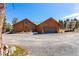 Charming home featuring wood exterior, a green roof, solar panels, a two car garage, and a circular driveway at 14800 Gold Hill Rd, Boulder, CO 80302
