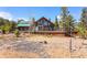Stunning exterior showcasing a spacious deck and a wall of windows, perfect for enjoying the natural surroundings at 14800 Gold Hill Rd, Boulder, CO 80302