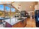 Kitchen with island, breakfast bar, and vaulted ceilings plus open floor plan to living space at 14800 Gold Hill Rd, Boulder, CO 80302