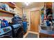 Functional laundry room equipped with a washer, dryer, utility sink, and storage at 14800 Gold Hill Rd, Boulder, CO 80302