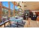 Bright living room with floor-to-ceiling windows, wood ceilings, dining area, and comfortable seating at 14800 Gold Hill Rd, Boulder, CO 80302