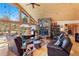 Cozy living room featuring a stone fireplace, wood paneling, vaulted ceilings, and comfortable leather seating at 14800 Gold Hill Rd, Boulder, CO 80302