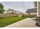 Well-maintained back yard with grass, a wood fence, shed and a concrete patio at 4426 Windmill Dr, Brighton, CO 80601