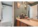 Bathroom vanity area leading to shower-tub combo with tile surround at 4426 Windmill Dr, Brighton, CO 80601