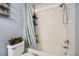 Bright bathroom features a shower-tub combo with white tile surround and modern fixtures at 4426 Windmill Dr, Brighton, CO 80601