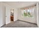 Well-lit bedroom with neutral carpet, white walls, and view of backyard trees at 4426 Windmill Dr, Brighton, CO 80601