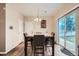 Dining room with dining table, chairs, and backyard access via sliding glass door at 4426 Windmill Dr, Brighton, CO 80601