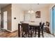 Dining room with dining table, 6 chairs, and backyard access via sliding glass door at 4426 Windmill Dr, Brighton, CO 80601