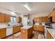 Functional kitchen featuring wooden cabinets, a center island, and modern appliances at 4426 Windmill Dr, Brighton, CO 80601