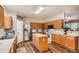 Well-lit kitchen with wood cabinets, white countertops, and stainless steel refrigerator at 4426 Windmill Dr, Brighton, CO 80601
