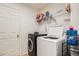 A modern laundry room features a front-load washer and top-load dryer at 4426 Windmill Dr, Brighton, CO 80601