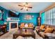 Living room featuring a cozy fireplace, stylish furnishings, and ample natural light at 4426 Windmill Dr, Brighton, CO 80601