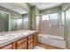 Well-lit bathroom featuring a dual-sink vanity, a shower-tub combo, and a large mirror at 3188 Soaring Eagle Ln, Castle Rock, CO 80109