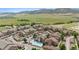 Scenic aerial view of apartment complex featuring a pool, parking, and mountain views at 10062 W Victoria Pl # 205, Littleton, CO 80127