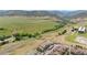 Expansive aerial view showcases the community, surrounding green space and mountain views at 10062 W Victoria Pl # 205, Littleton, CO 80127