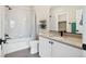 Modern bathroom featuring white cabinets, gray tile flooring, and shower-tub combination with stylish fixtures at 10062 W Victoria Pl # 205, Littleton, CO 80127