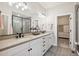Contemporary bathroom features a double sink vanity, and a glass-enclosed shower with tiled walls at 10062 W Victoria Pl # 205, Littleton, CO 80127