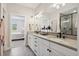 Spacious bathroom featuring double sinks, ample storage, and a walk-in shower at 10062 W Victoria Pl # 205, Littleton, CO 80127
