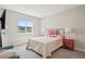 Bedroom with TV, scenic views from the window, two side tables and a comfortable sitting bench at 10062 W Victoria Pl # 205, Littleton, CO 80127