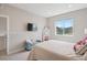 Inviting bedroom with scenic views from the bright window with a blue bench and soft color palette at 10062 W Victoria Pl # 205, Littleton, CO 80127