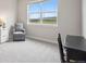 Bright bedroom with large window showcasing beautiful landscape views and comfortable seating area at 10062 W Victoria Pl # 205, Littleton, CO 80127
