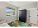 Bedroom features an armoire and a large window that lets in plenty of natural light and shows a lovely view at 10062 W Victoria Pl # 205, Littleton, CO 80127