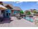 Relaxing outdoor deck area with seating, offering views of the pool and community buildings at 10062 W Victoria Pl # 205, Littleton, CO 80127