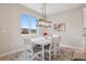 Inviting dining area featuring a modern chandelier, neutral walls and plenty of natural light at 10062 W Victoria Pl # 205, Littleton, CO 80127
