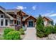 Community building entrance with stone accents, blue doors, and attractive landscaping at 10062 W Victoria Pl # 205, Littleton, CO 80127