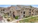 Well-maintained apartment building with stone accents and manicured landscaping at 10062 W Victoria Pl # 205, Littleton, CO 80127