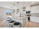 Open concept kitchen with a big island, modern pendant lights and stainless steel appliances at 10062 W Victoria Pl # 205, Littleton, CO 80127