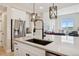 Bright and airy kitchen with stainless steel appliances and a large island at 10062 W Victoria Pl # 205, Littleton, CO 80127