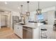 Well-designed kitchen with stainless steel appliances, a large island, and easy access to the living area at 10062 W Victoria Pl # 205, Littleton, CO 80127