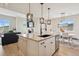 Open kitchen and living area featuring an island with pendant lights and stainless steel appliances at 10062 W Victoria Pl # 205, Littleton, CO 80127