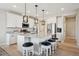 Modern kitchen featuring a large island, stylish pendant lighting, and white cabinetry at 10062 W Victoria Pl # 205, Littleton, CO 80127