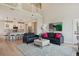 Contemporary living space with a connecting kitchen, a plush sofa, and stylish decor creates an inviting atmosphere at 10062 W Victoria Pl # 205, Littleton, CO 80127