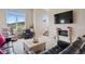 Open-concept living space with a fireplace, large windows, and plush seating, offers comfort and style at 10062 W Victoria Pl # 205, Littleton, CO 80127