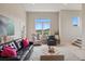 Inviting living room with comfortable seating, a decorative rug, and scenic views from the large window at 10062 W Victoria Pl # 205, Littleton, CO 80127