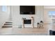 Stylish living room with a modern fireplace, hardwood floors, and ample natural light, offering a cozy atmosphere at 10062 W Victoria Pl # 205, Littleton, CO 80127