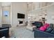 A spacious living room with high ceilings, a fireplace, and an open layout, provides a modern and airy feel at 10062 W Victoria Pl # 205, Littleton, CO 80127