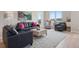 Bright living room featuring modern furnishings and light wood floors, perfect for relaxing or entertaining at 10062 W Victoria Pl # 205, Littleton, CO 80127