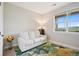 Cozy sitting room features a comfortable couch, bright window and views of the green landscape beyond at 10062 W Victoria Pl # 205, Littleton, CO 80127