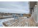 This backyard deck has views of neighborhood, includes two chairs, and is covered with snow at 2723 E 96Th Way, Thornton, CO 80229