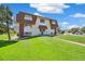 Inviting apartment building with a manicured lawn and a charming front entrance at 10211 Ura Ln # 3-104, Thornton, CO 80260