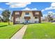 Well-maintained apartment building with lush greenery and a welcoming entrance at 10211 Ura Ln # 3-104, Thornton, CO 80260