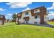 Charming apartment building featuring well-maintained landscaping and inviting facade under a blue sky at 10211 Ura Ln # 3-104, Thornton, CO 80260