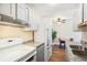 Bright kitchen offering white appliances, granite countertops, and an eat-in area with a ceiling fan at 10211 Ura Ln # 3-104, Thornton, CO 80260